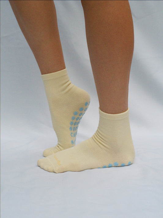 Yellow socks with blue daisy grips