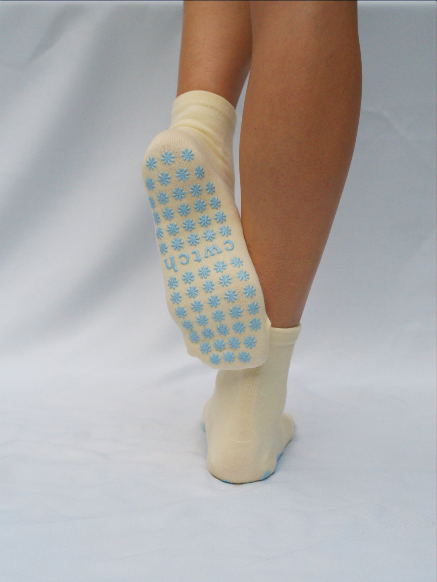 Yellow socks with blue daisy grips
